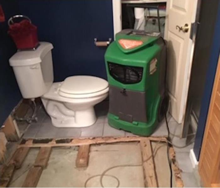 Bathroom with SERVPRO equipment and controlled demolition on the floating floor
