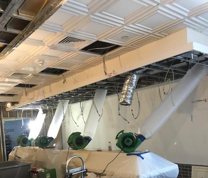 SERVPRO equipment forcing air into the water damaged ceiling
