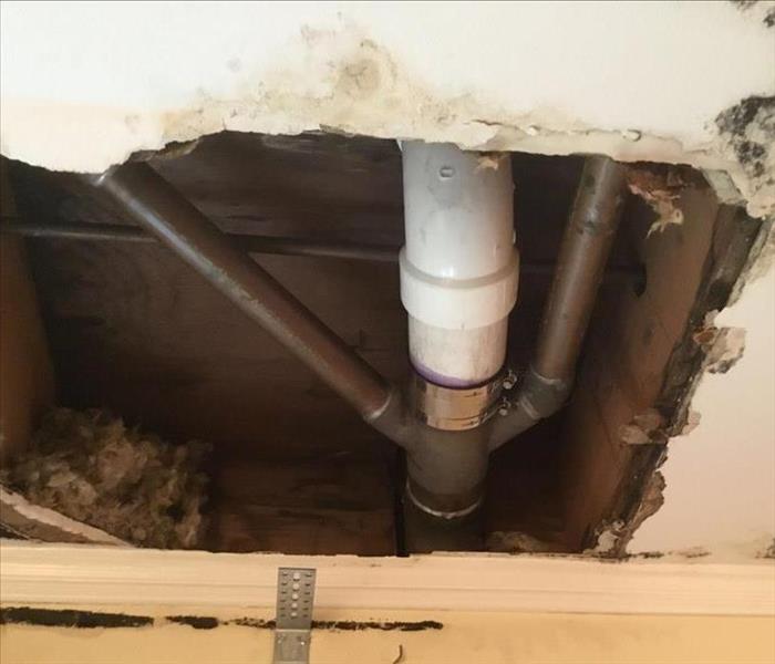 water damage leaking drain pipe in ceiling